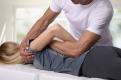 Woman having chiropractic back adjustment. Osteopathy, Acupressure, Alternative medicine, pain relief concept. Physiotherapy, sport injury rehabilitation